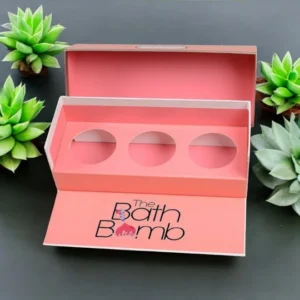 Four corner bath bomb box with insert in a pink color, displaying an assortment of colorful bath bombs inside.