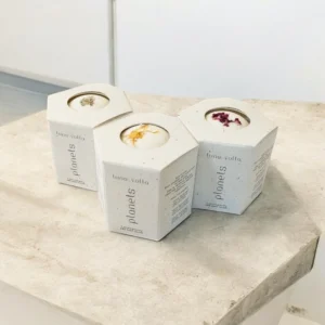 A set of three hexagonal bath bomb boxes made of textured, eco-friendly material. Each box has an open-top design revealing a bath bomb with dried floral toppings, labeled "Luna Volta Planets.
