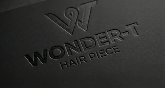 Technical close-up of a blind debossed logo on thick black cardstock, highlighting the elegant recessed texture and depth without ink for a minimalist look.