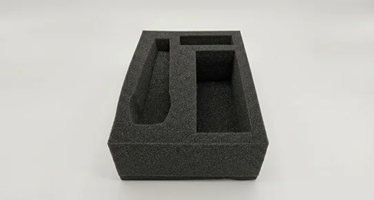 Soft charcoal-colored die-cut foam insert providing lightweight cushioning and scratch protection for delicate electronic or cosmetic products.