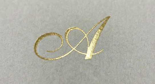 Close-up of a premium custom box featuring intricate gold foil logo detailing.