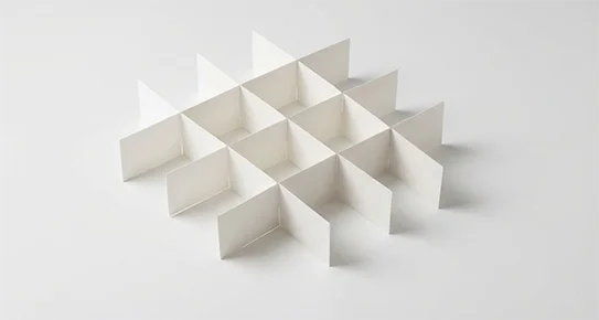 Interlocking cardboard fence dividers used to separate and protect multiple fragile items, such as jars or bottles, during transit.