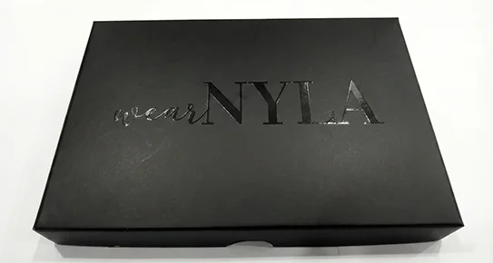 Custom matte black gift box featuring a high-gloss spot UV finish on the brand logo, showcasing a premium reflective contrast for luxury packaging.