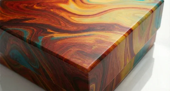 Premium rigid magnetic box with an orange and brown marble print, showcasing a non-reflective matte finish for a sophisticated, modern look.