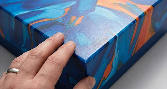 Close-up of a colorful luxury rigid box featuring a non-reflective soft-touch finish and velvety texture for a premium unboxing experience.